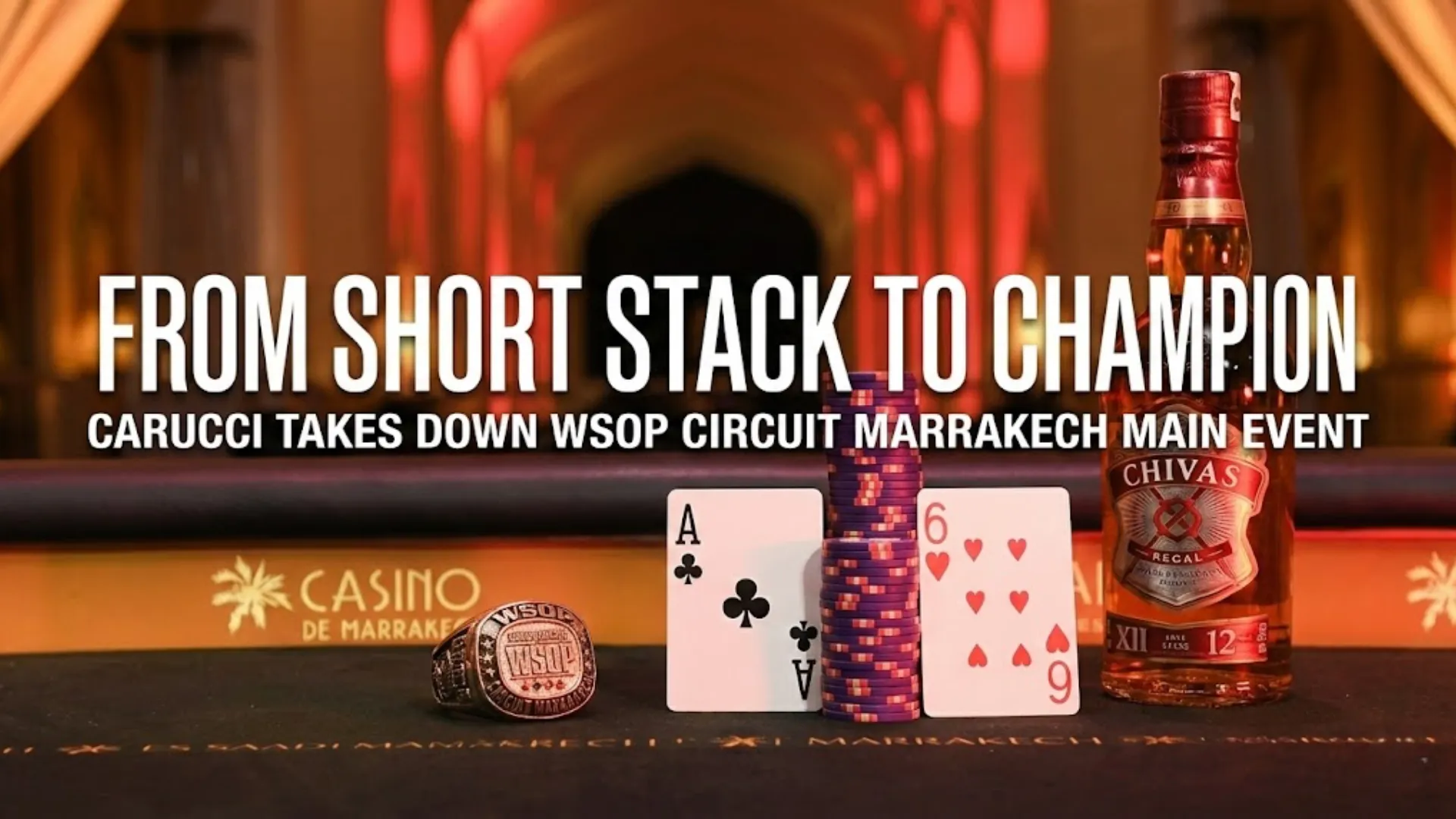 Sandro Carucci's WSOP Circuit Marrakech Main Event championship ring, A-6 playing cards, poker chips, and Chivas Regal bottle on a felt table.