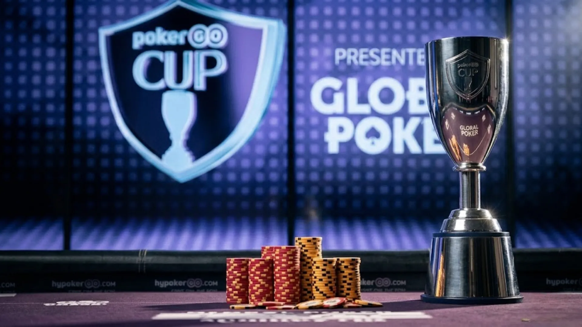 Silver PokerGO Cup trophy and poker chips on a table, presented by Global Poker - PokerOffer
