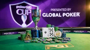 緑のフェルトテーブルに置かれたPokerGO Cupトロフィーとトランプ、Global Pokerが冠スポンサー