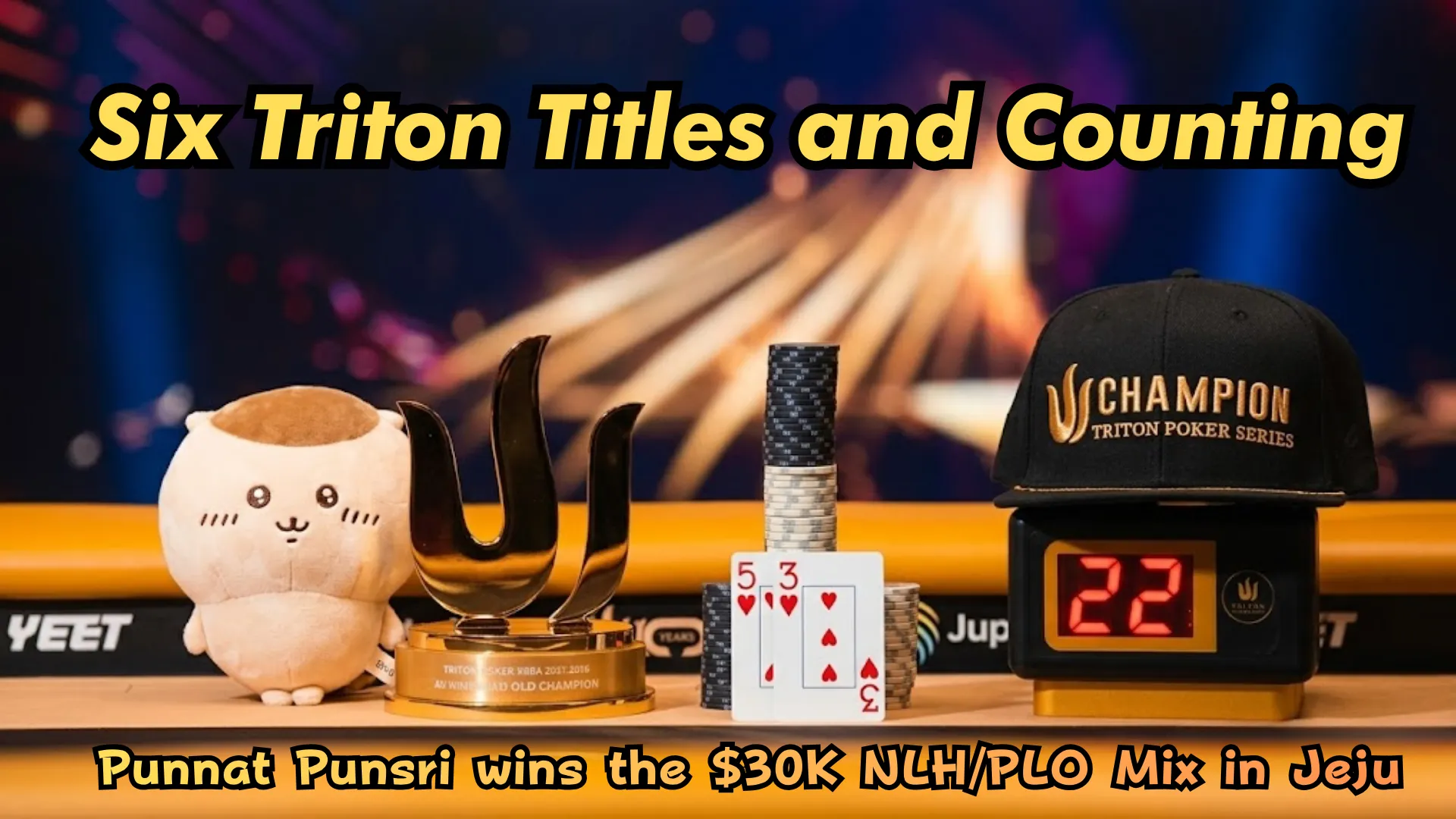 Punnat Punsri wins sixth Triton Poker title at the $30,000 NLH/PLO Mix in Jeju 2026, with Triton trophy, champion cap, and winning hole cards 5-3 on display